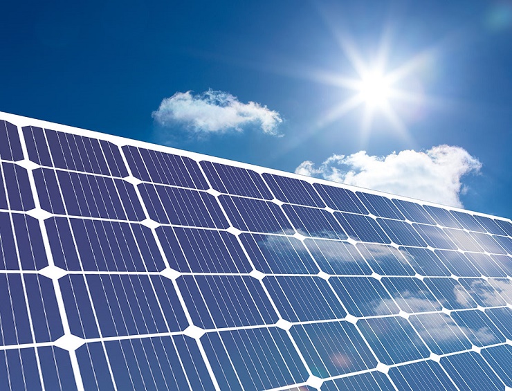 Solar panel reflecting sunlight against a blue sky